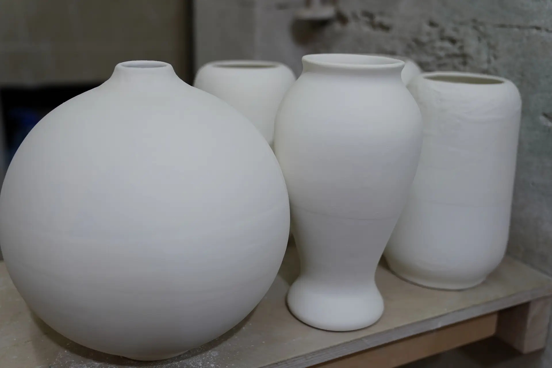 Minimalist white ceramic vases on a shelf