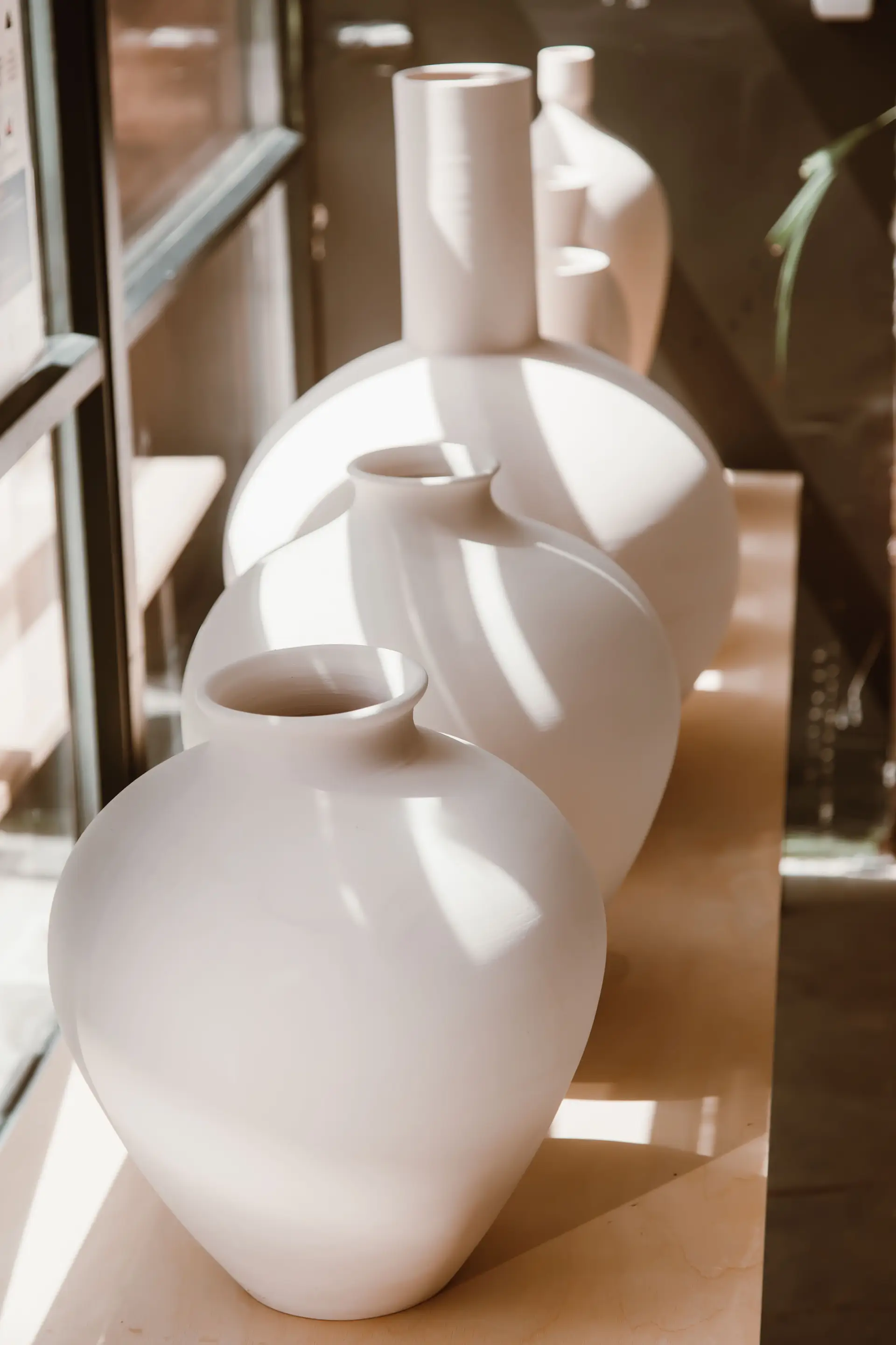 Atmospheric ivory ceramic vessels in soft New Zealand light