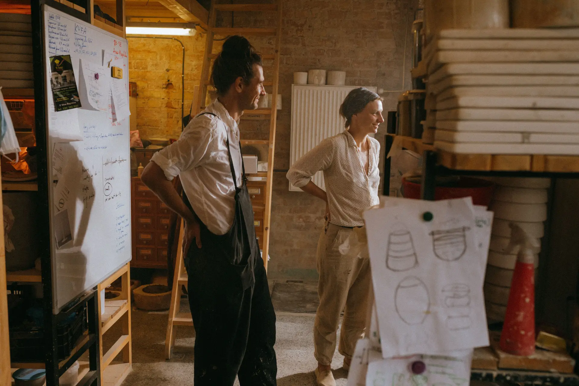 Artisans discussing designs in the sunlit studio