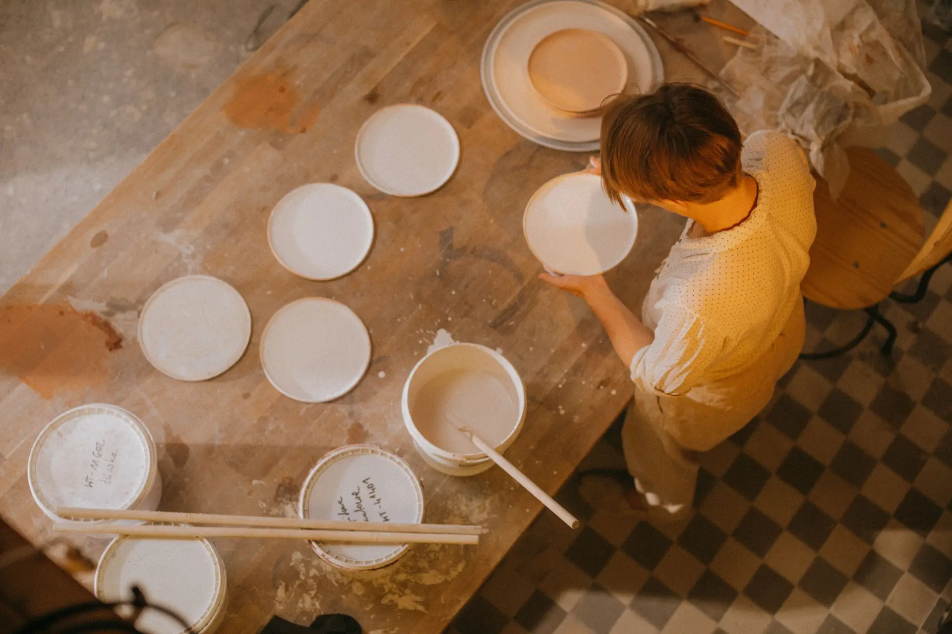 Aerial view of an artisan crafting a ceramic plate